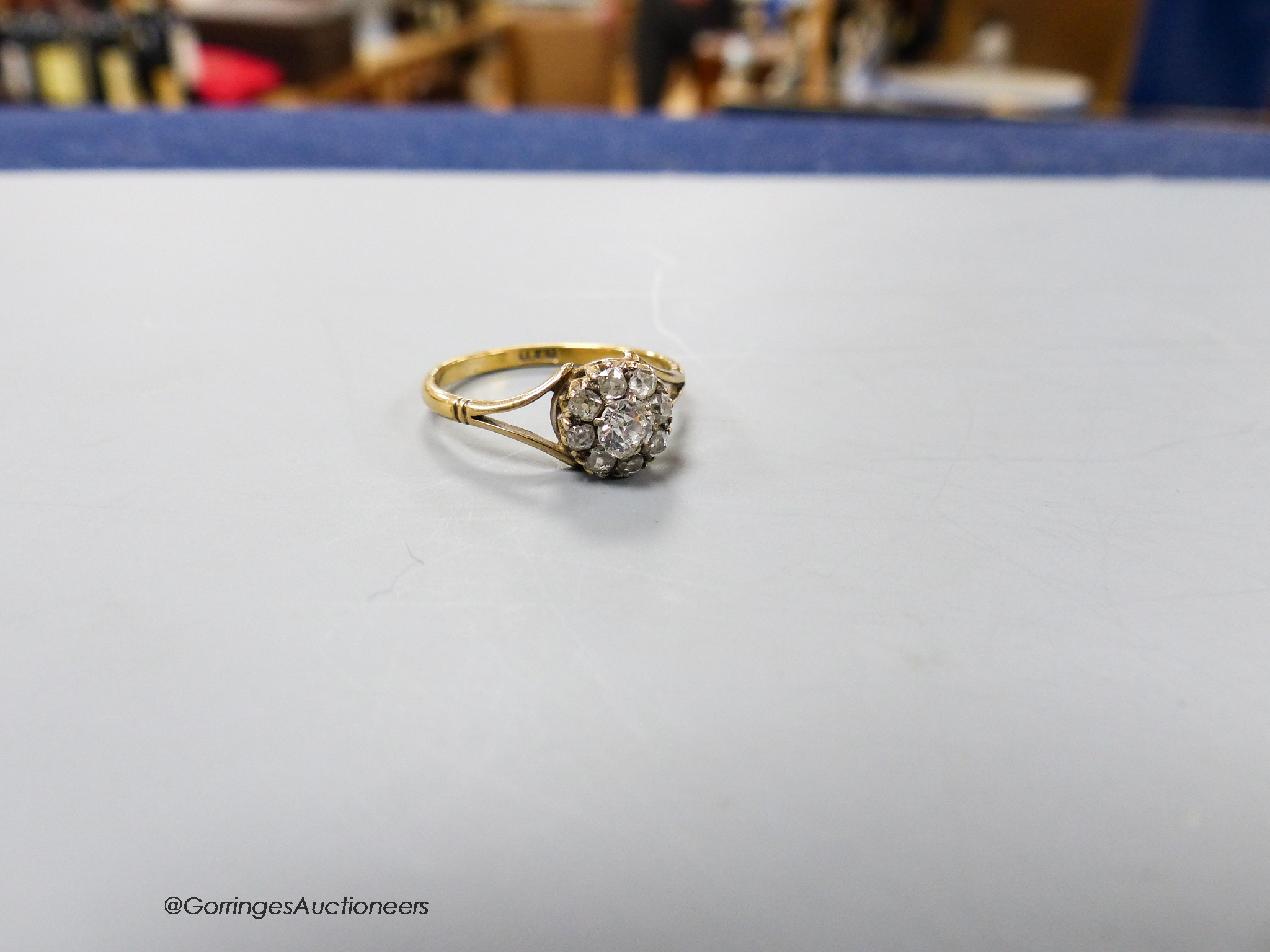 An 18ct and old round cut diamond set cluster ring, size Q, gross weight 2.5 grams.